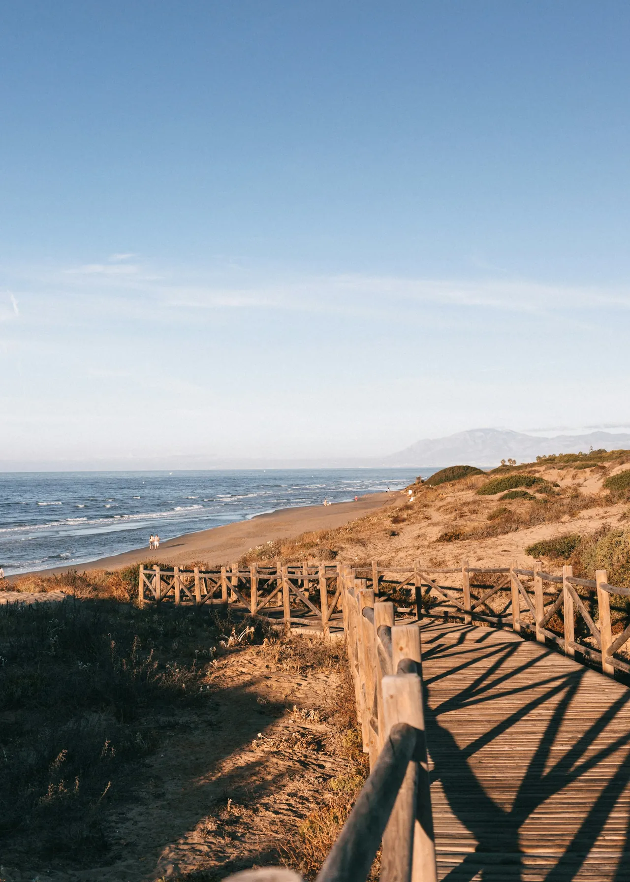 A wooden walkway over the dunes towards the beach at Cabopino