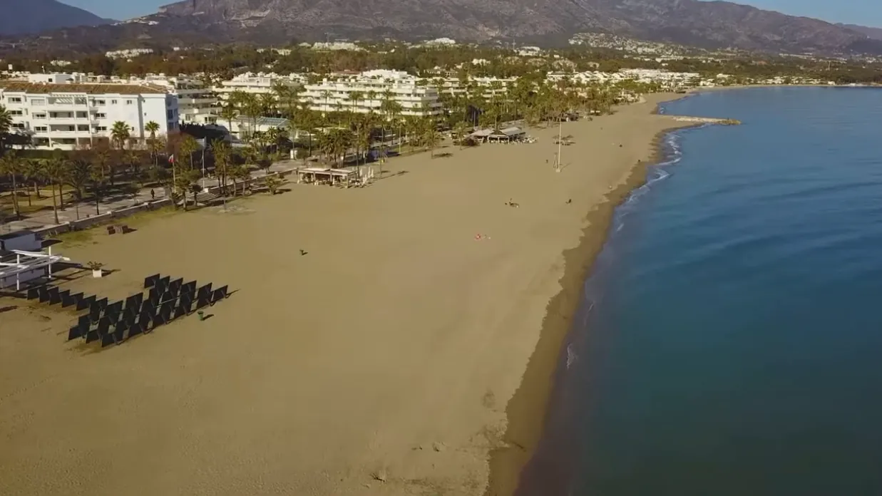 A long sandy beach of Marbella near Puerto Banús, from the air