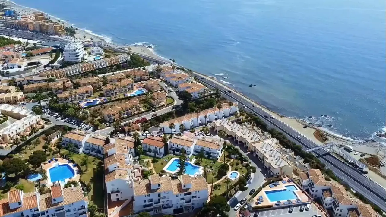 The coast road and the shore at El Faro, Mijas Costa, from the air