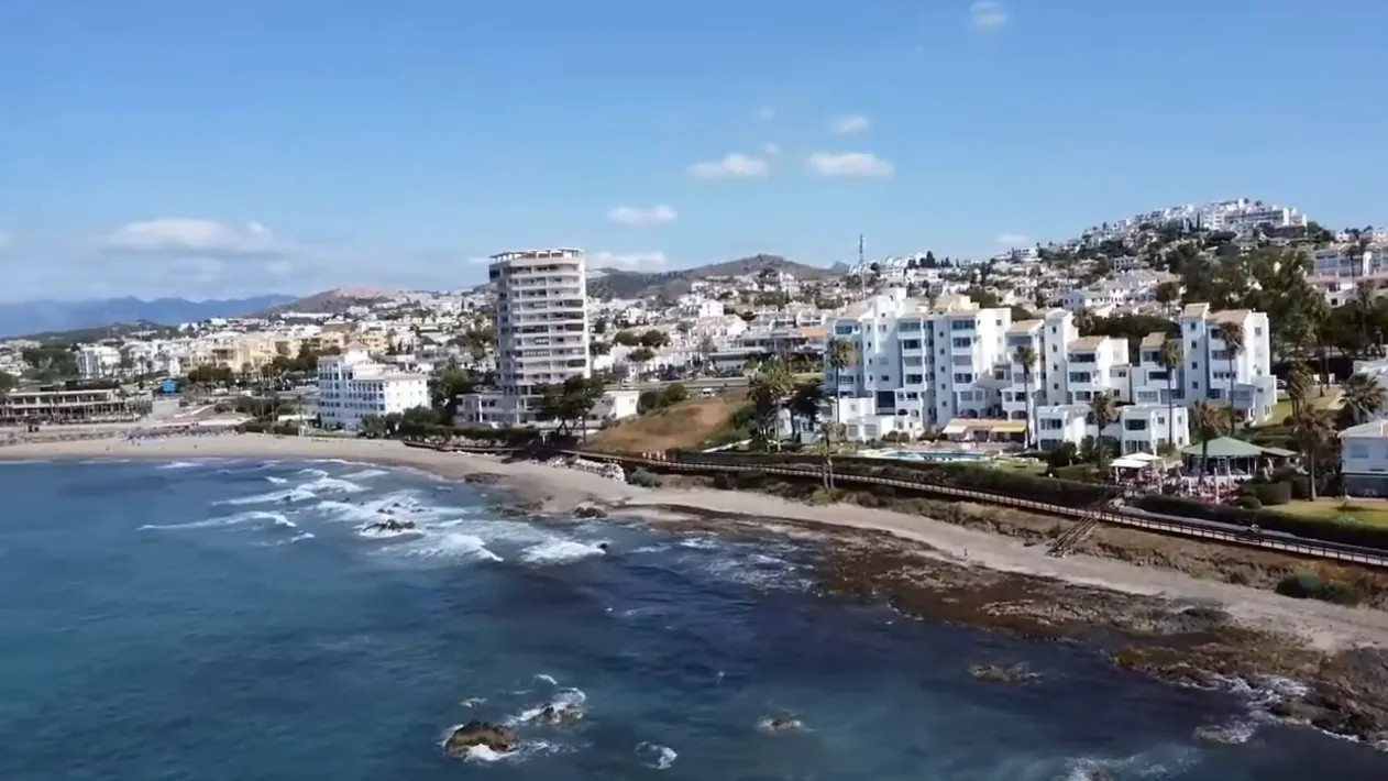 The rocky shore and the houses of Riviera del Sol, from the air