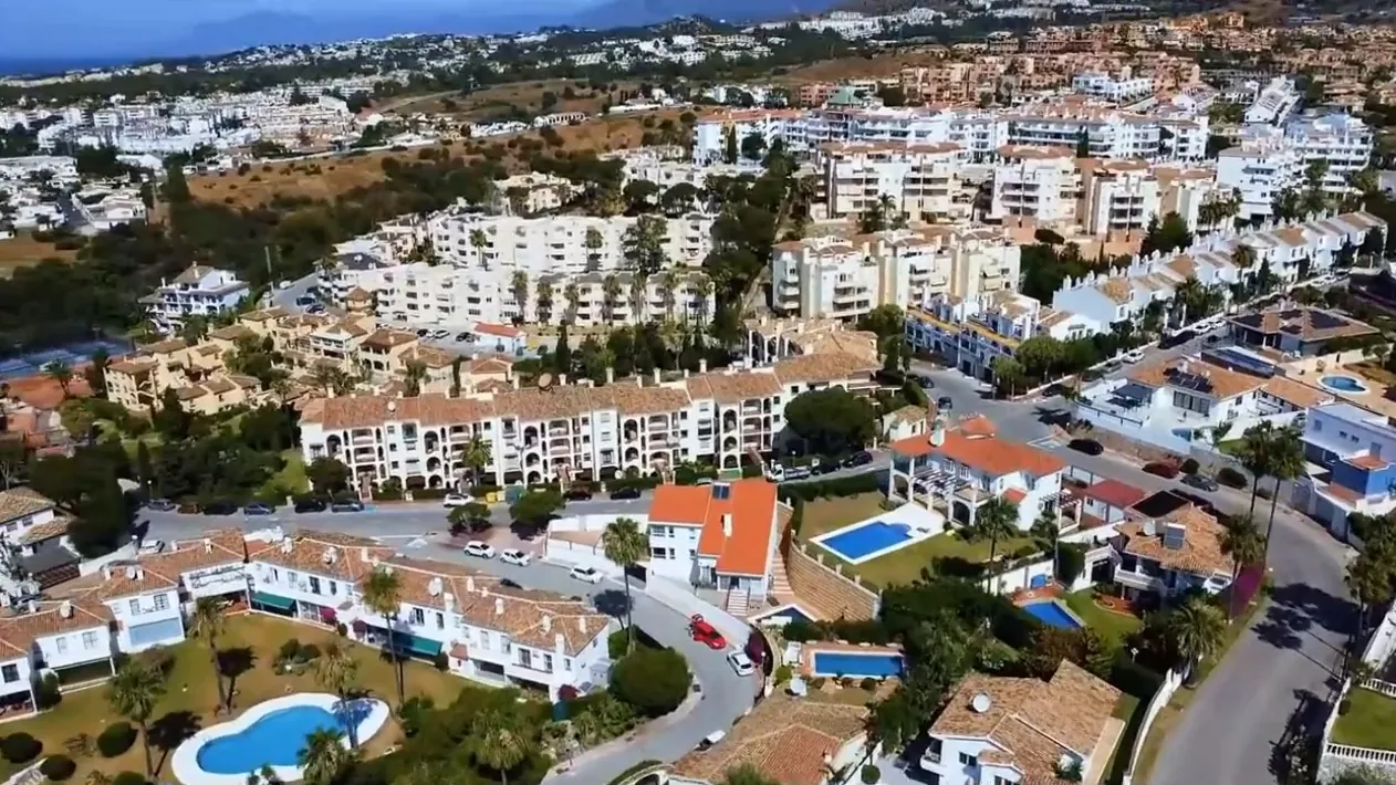 Homes and gardens of Riviera del Sol between the hills and the sea, from the air